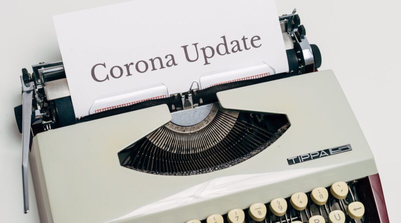 a vintage typewriter with corona update typed on white paper